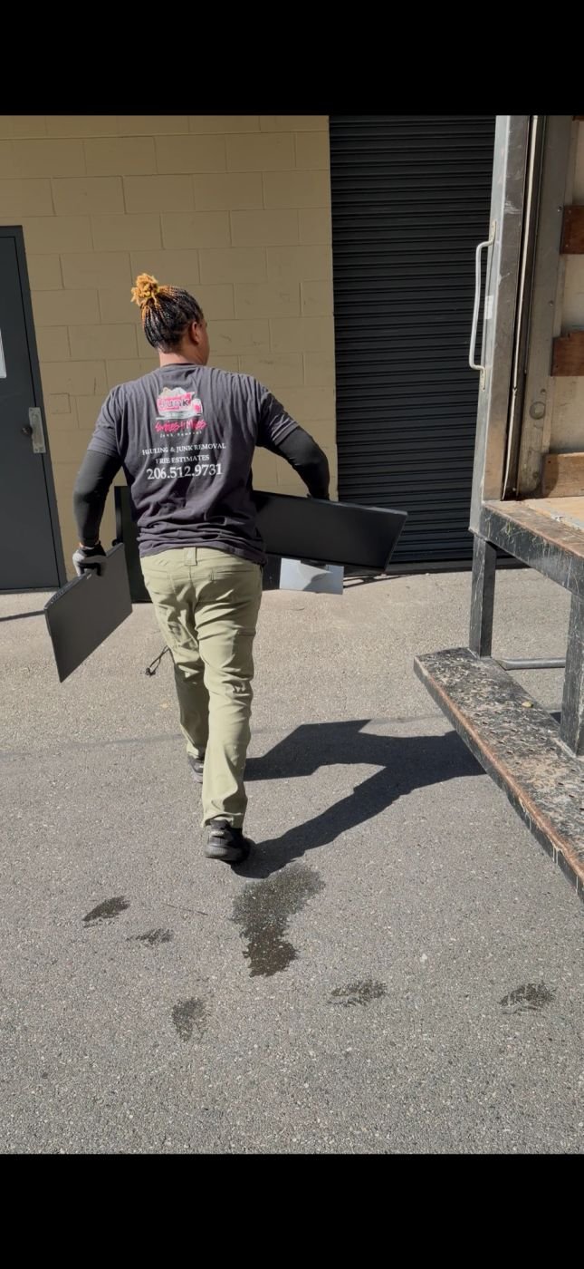 Smiles 4 Miles crew carrying old monitors out for recycling in Kent