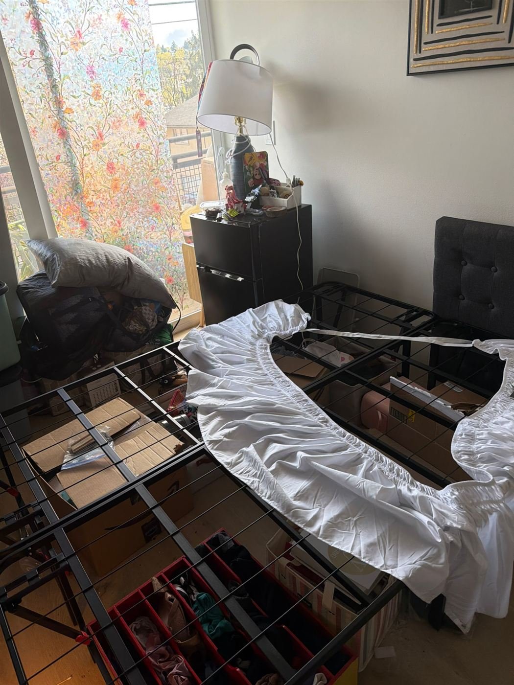 Cluttered bedroom before furniture removal in Edmonds