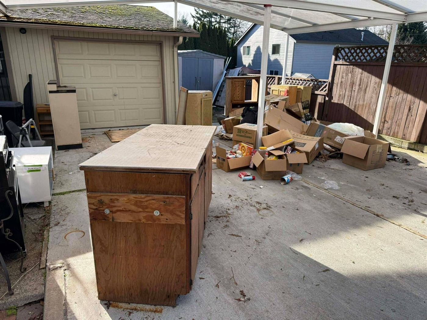 Furniture staged in a carport before pickup in Edmonds