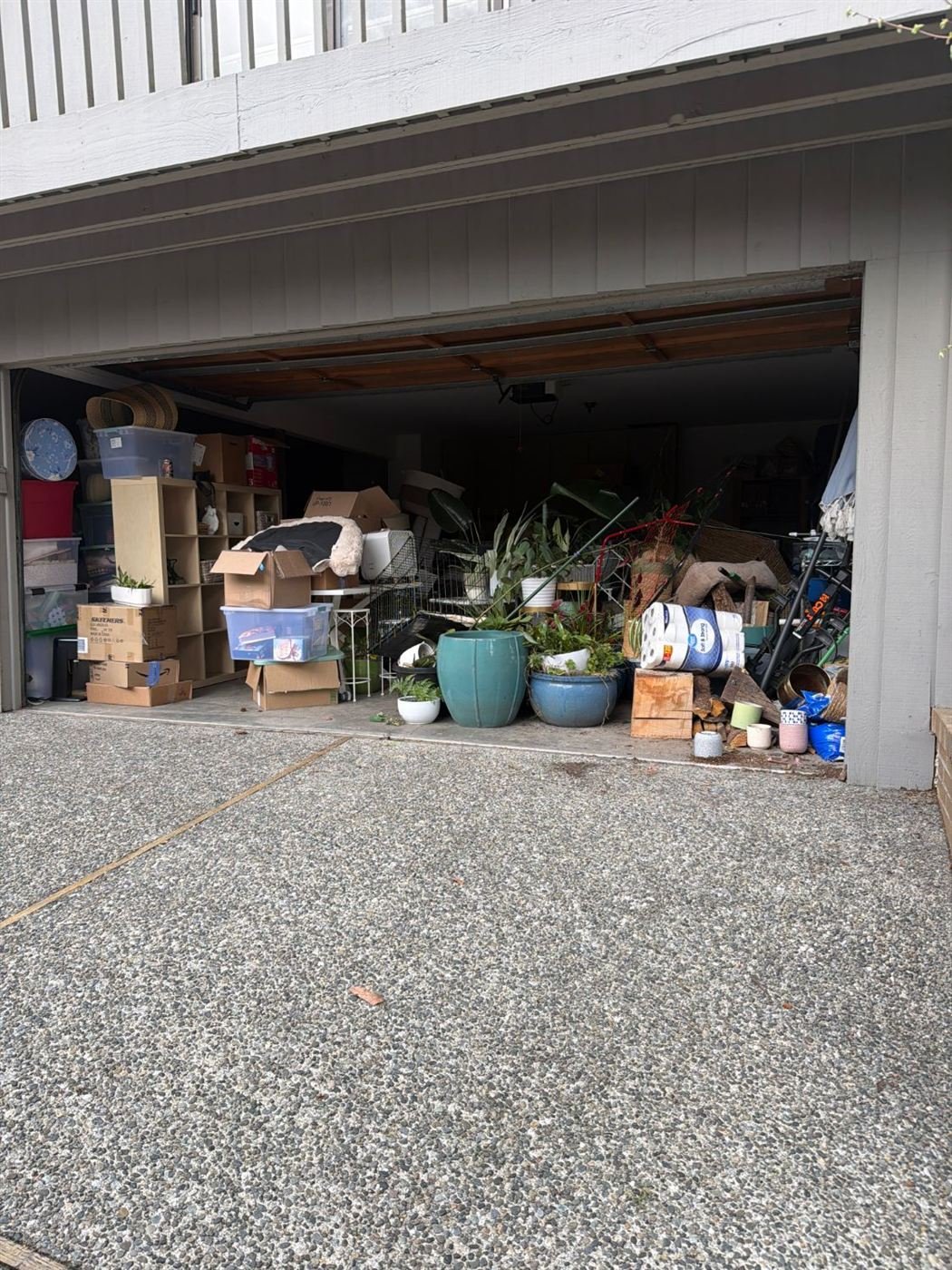 Garage packed with boxes and bins before cleanout in Edmonds