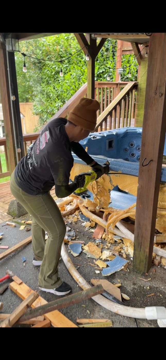 Crew breaking down a hot tub shell in Bellevue