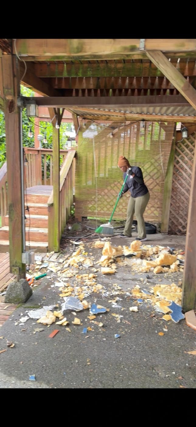 Crew sweeping up hot tub debris after removal in Edmonds