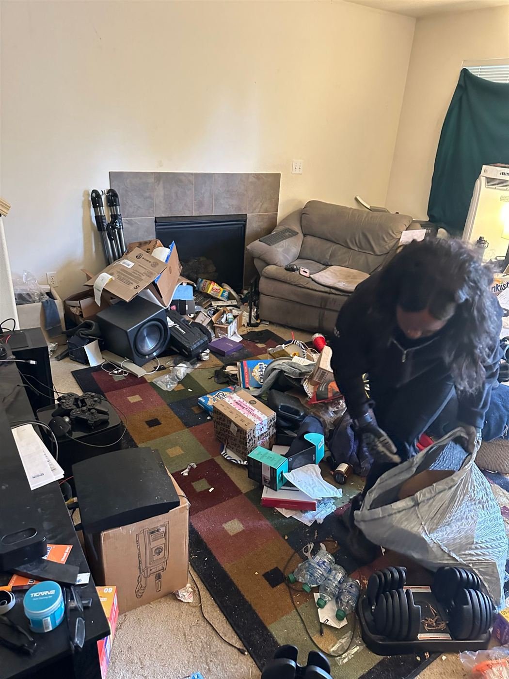 Smiles 4 Miles crew clearing a cluttered living room in Kent