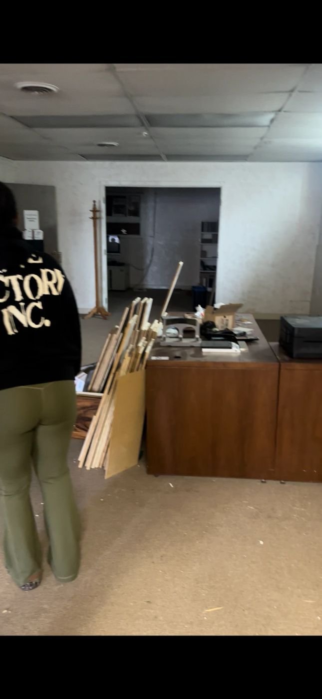 Crew clearing an office space of debris and old furniture